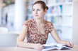 pretty young college student in a library
