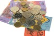 Australian banknotes and coins on plain white background