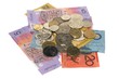 Australian banknotes and coins on plain white background