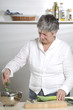 Women is cutting leek in the kitchen