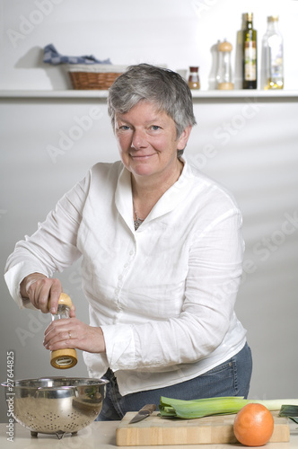 Photo: Women is a pepper mill in the kitchen Women is a pepper mill in the kitchen
