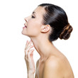 beautiful woman touching by fingers her neck