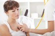 doctor using stethoscope on patient