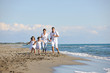 happy young  family have fun on beach