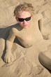 Boy relaxing on summer beach in sunglasses