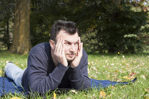 Photo: Young Adult Relaxing in the Park Young Adult Relaxing in the Park