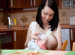 a mother is feeding her baby from a bottle