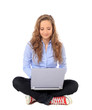 Foto: Junge Frau sitzt im Schneidersitz und arbeitet am Computer Junge Frau sitzt im Schneidersitz und arbeitet am Computer
