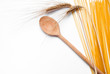 pasta, wooden spoon and a ear of wheat pasta, wooden spoon and a ear of wheat