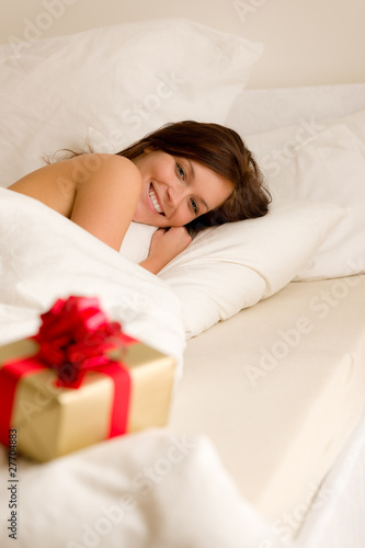 Photo: Bedroom surprise present - young happy woman Bedroom surprise present - young happy woman