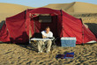 Man with laptop and portable solar charger