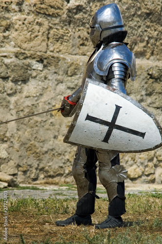 Photo: Medieval european knight near citadel wall Medieval european knight near citadel wall