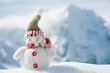 Happy snowman in mountains