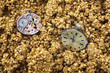 The mechanism of analog watch on the golden sand