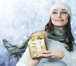 Beautiful Happy Girl with Christmas Gift.Snow