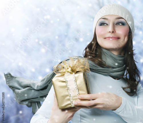 Photo: Beautiful Happy Girl with Christmas Gift.Snow Beautiful Happy Girl with Christmas Gift.Snow