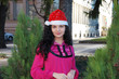 YOUNG LADY WITH SANTA CLAUS HAT