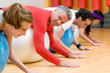Exercising with fitness ball at gym
