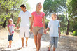 Foto: Family, parents and children, walking together in park Family, parents and children, walking together in park