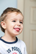 Cute little boy showing tongue