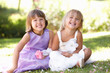 Two young girls posing in park Two young girls posing in park