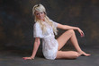Cute young blond woman sitting