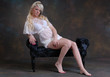 Pretty young woman sat on lounger