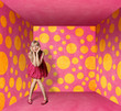 surprised blonde in pink dress in pink room