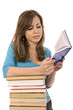 beautiful girl thoughtfully reading a book, surrounded by books