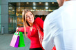 Woman dragging man into shopping mall Woman dragging man into shopping mall