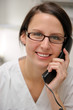 Photographie : Zahnarzthelferin telefoniert mit einem Patienten