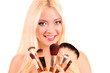 Beautiful young blonde woman with bright make-up and many brushe Beautiful young blonde woman with bright make-up and many brushe