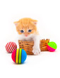 Red kitten in a wattled basket with multi-colored balls Red kitten in a wattled basket with multi-colored balls