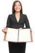 Businesswoman showing blank notebook copyspace