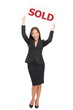 Realtor happy showing sold sign