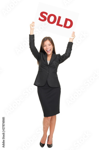 Photo: Realtor happy showing sold sign Realtor happy showing sold sign