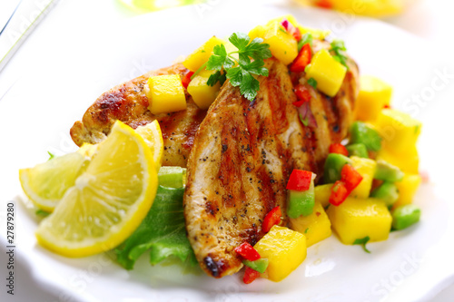 Photo: Grilled chicken breast with fresh mango salsa, soft focus Grilled chicken breast with fresh mango salsa, soft focus
