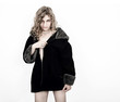 Beautiful girl posing, wearing only jacket and pearls