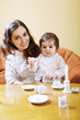 Smiling mother playing with daughter