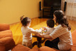 Mother playing with daughters at home