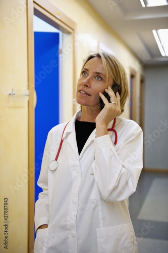 Photo: Doctor making telephone call in medical center Doctor making telephone call in medical center