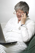 Women is working on laptop and calling by phone