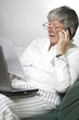 Women is working on laptop and calling by phone