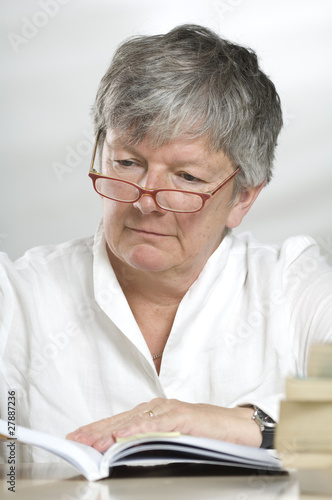 Photo: Adult women studying while reading a book Adult women studying while reading a book