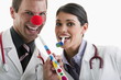 Male and female doctors with party toys