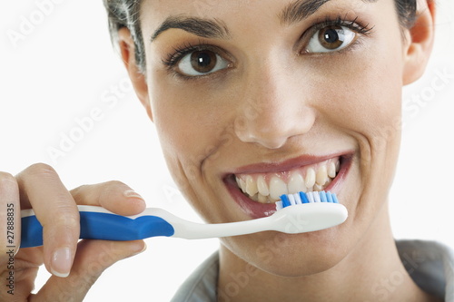 Photo: Young woman holding toothbrush Young woman holding toothbrush