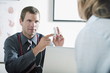 Doctor holding bottle of pills for patient