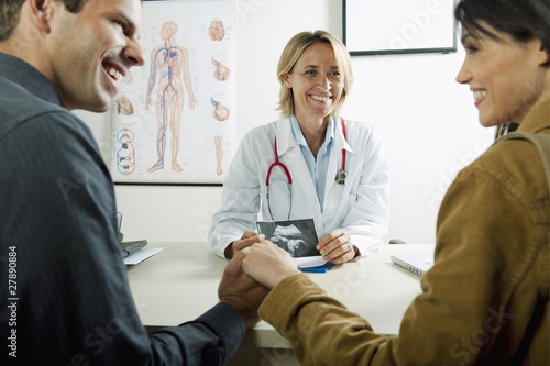 Photo: Doctor with ultrasound and couple Doctor with ultrasound and couple