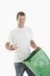 Man throwing paper in the recycling bin