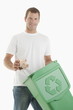 Man throwing paper in the recycling bin